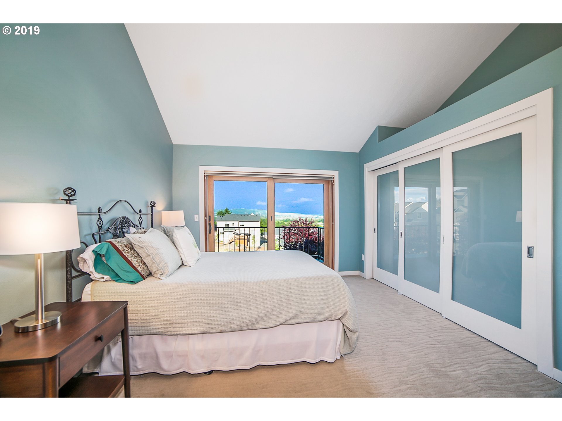 1119 Southwest 1st Street Dundee, OR 97115 - Photo 18 of 32 a bedroom with a bed a table and a large mirror