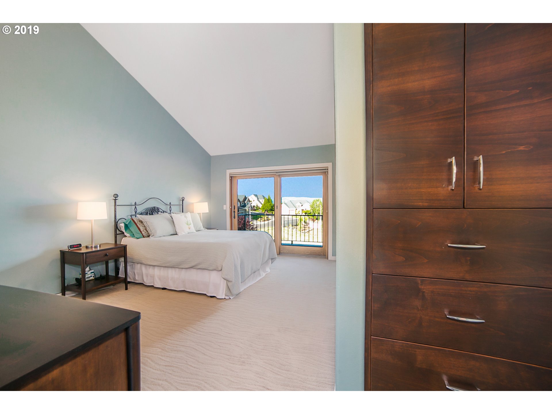 1119 Southwest 1st Street Dundee, OR 97115 - Photo 19 of 32 a bedroom with a bed and a night stand