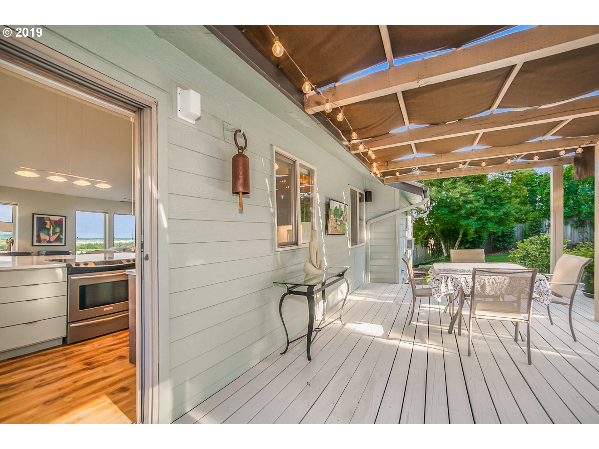 1119 Southwest 1st Street Dundee, OR 97115 - Photo 26 of 32 a view of a patio with dining table and chairs with wooden floor