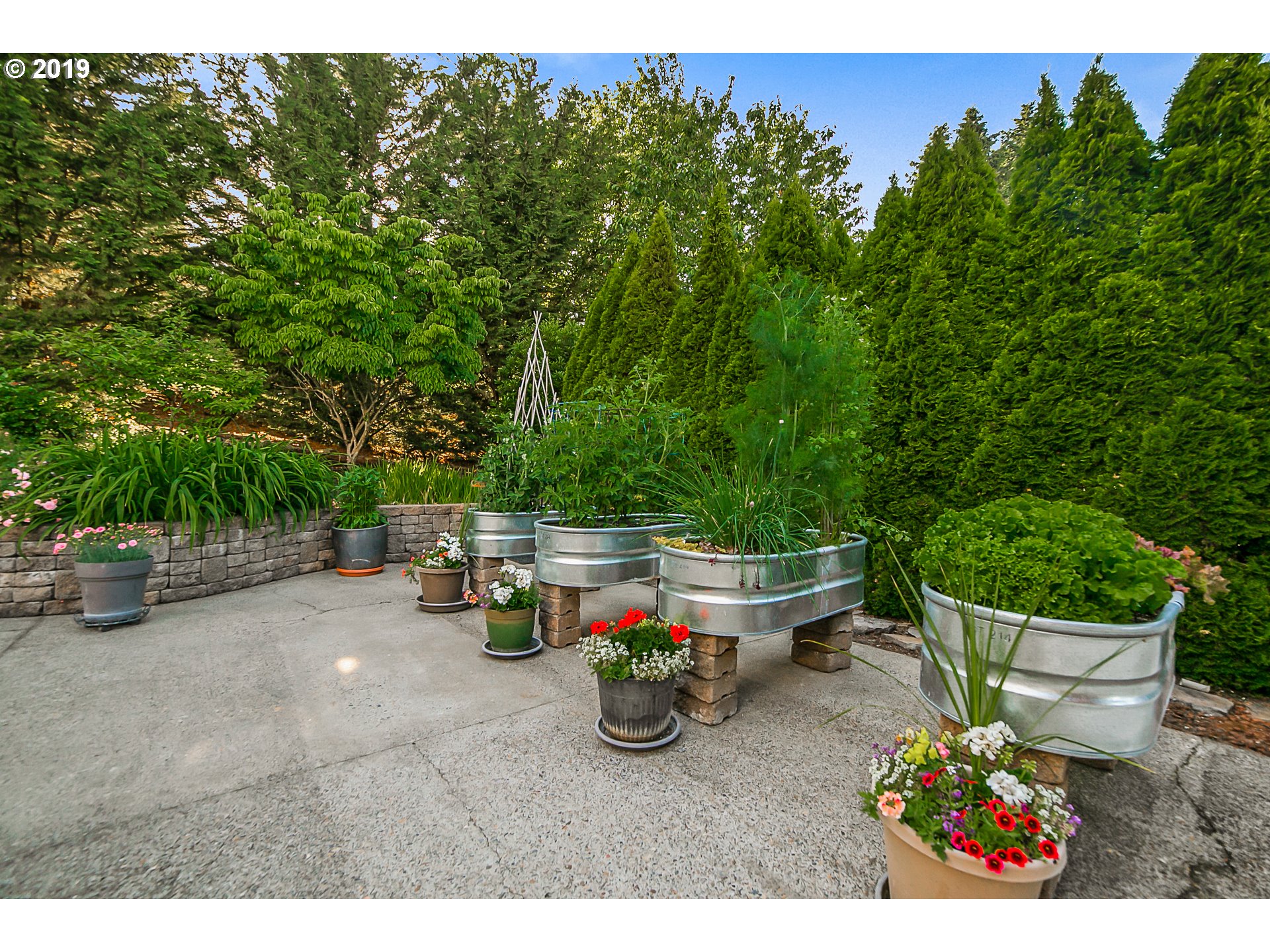 1119 Southwest 1st Street Dundee, OR 97115 - Photo 31 of 32 a view of a patio with table and chairs potted plants with wooden fence