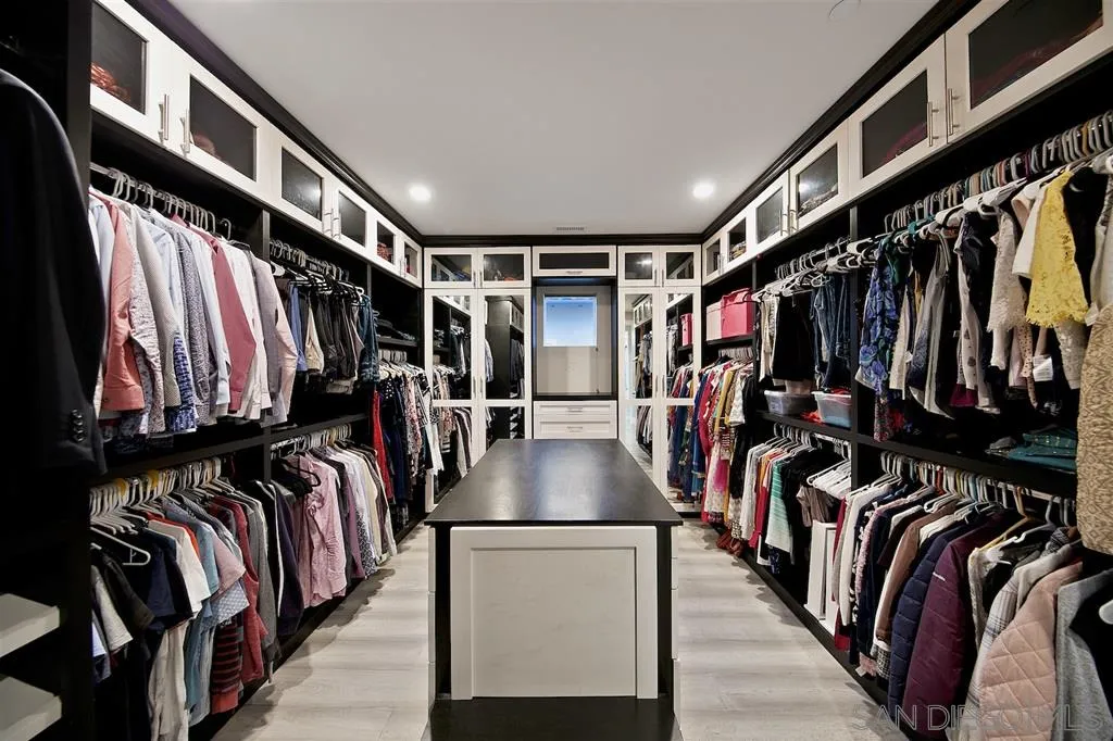 16438 Nicole Ridge Road San Diego, CA 92127 - Photo 15 of 25 a view of walk in closet with clothes and shoes