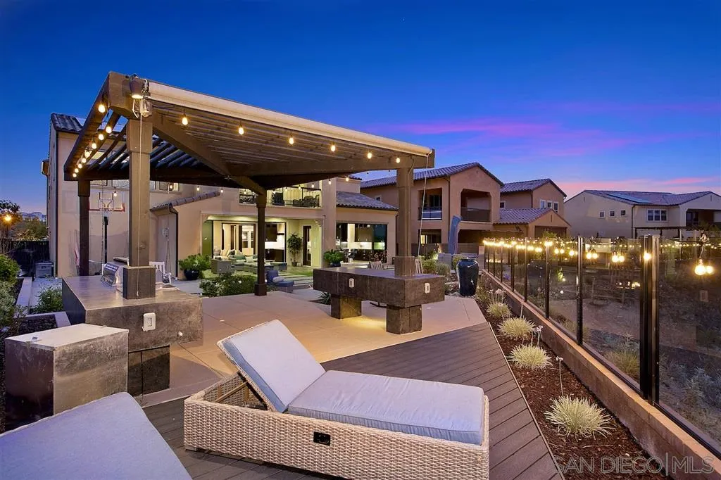 16438 Nicole Ridge Road San Diego, CA 92127 - Photo 19 of 25 a view of a patio with couches table and chairs with wooden floor and fence