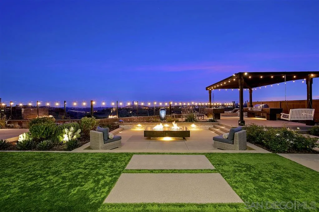 16438 Nicole Ridge Road San Diego, CA 92127 - Photo 24 of 25 a view of a swimming pool with a table and chairs under an umbrella