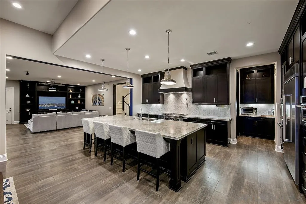 16438 Nicole Ridge Road San Diego, CA 92127 - Photo 4 of 25 a large kitchen with a table and chairs