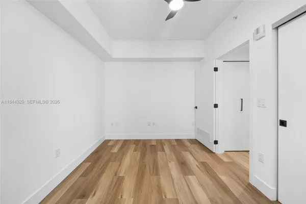a view of a room with wooden floor and small staircase