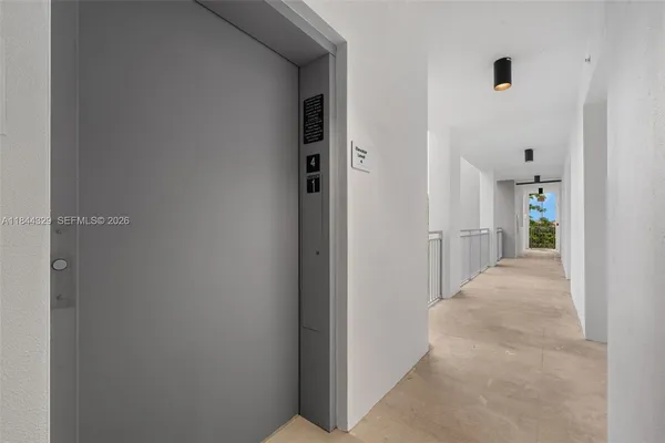 a view of a hallway with wooden shelves