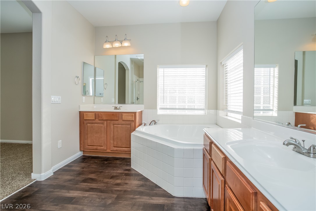 7630 Riva Ridge Street Las Vegas, NV 89149 - Photo 7 of 14 Gleaming hardwood floors and a deep soaking tub anchor this spacious main bathroom.