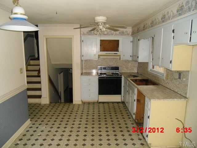 5005 Oak Park Road Raleigh, NC 27612 - Photo 4 of 9 a kitchen with a sink stove and refrigerator