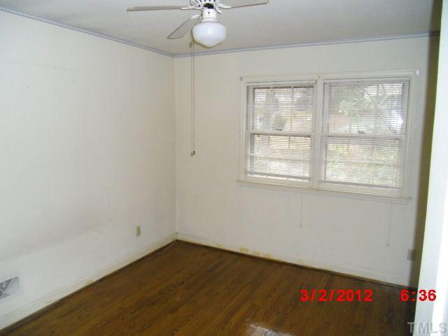 5005 Oak Park Road Raleigh, NC 27612 - Photo 5 of 9 an empty room with a window