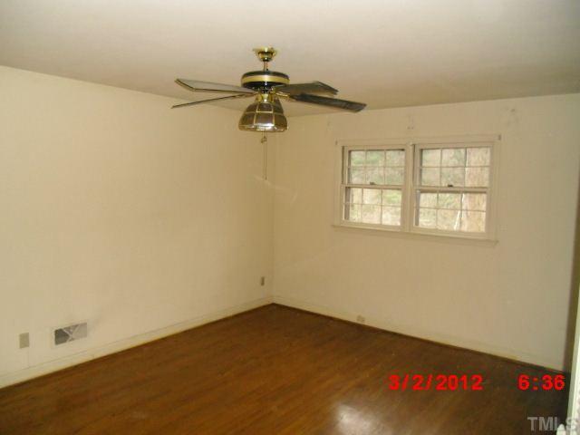 5005 Oak Park Road Raleigh, NC 27612 - Photo 6 of 9 an empty room with a window