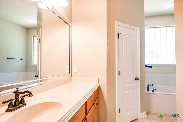 a bathroom with a tub shower and a sink