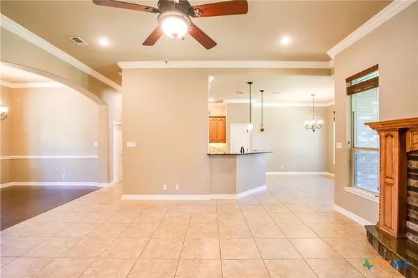 a view of an empty room with a fireplace