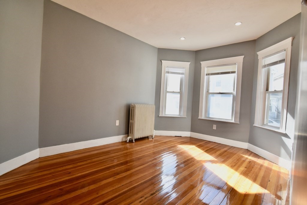 21 Treadway Road, Unit 2 Boston, MA 02125 - Photo 7 of 21 a view of a livingroom with wooden floor and a window
