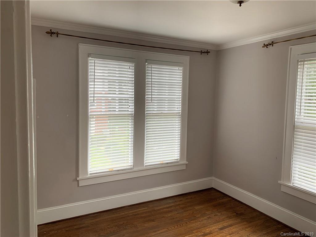 224 Providence Road Charlotte, NC 28207 - Photo 11 of 27 a view of an empty room with wooden floor and a window