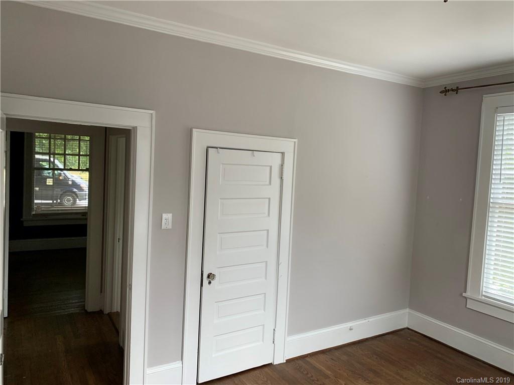 224 Providence Road Charlotte, NC 28207 - Photo 12 of 27 a view of an empty room with wooden floor and a window