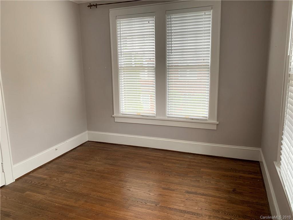 224 Providence Road Charlotte, NC 28207 - Photo 14 of 27 an empty room with wooden floor and a window