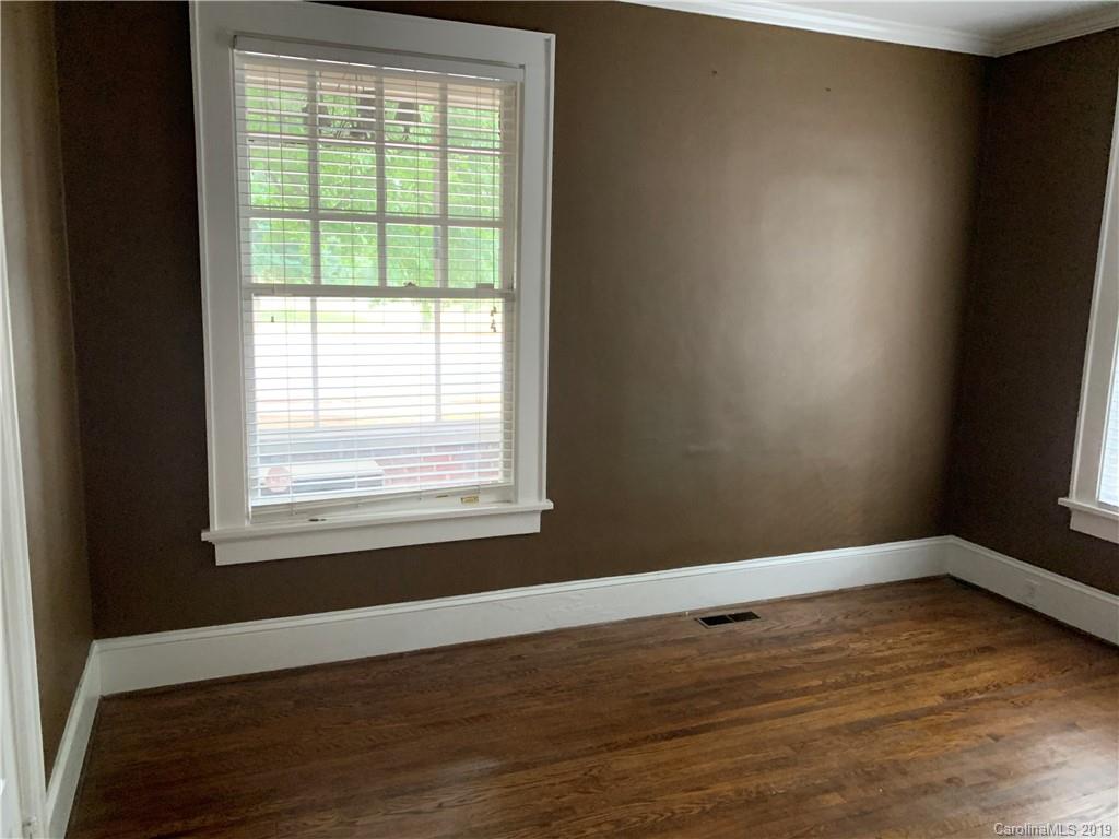 224 Providence Road Charlotte, NC 28207 - Photo 15 of 27 a view of an empty room with wooden floor and a window