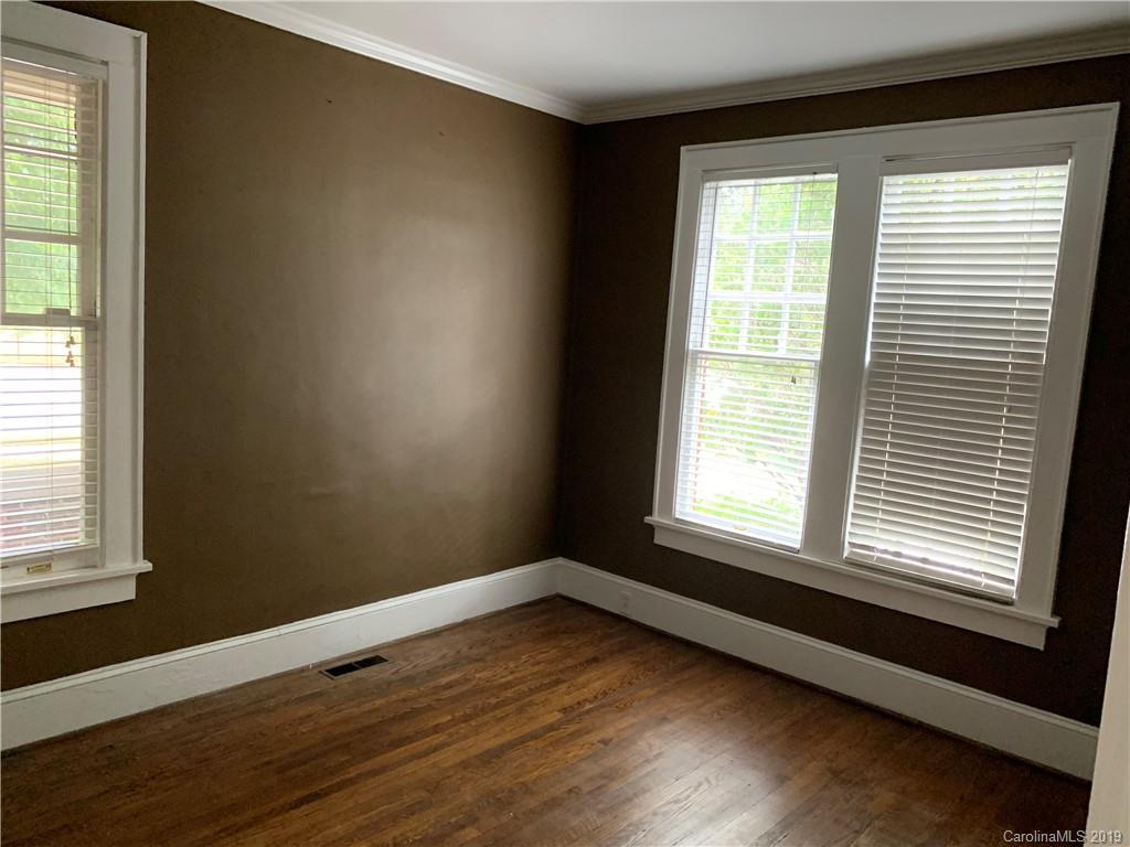224 Providence Road Charlotte, NC 28207 - Photo 16 of 27 a view of an empty room with wooden floor and a window