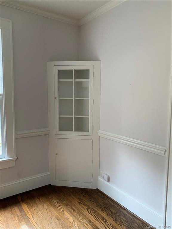 224 Providence Road Charlotte, NC 28207 - Photo 21 of 27 an empty room with wooden floor and windows