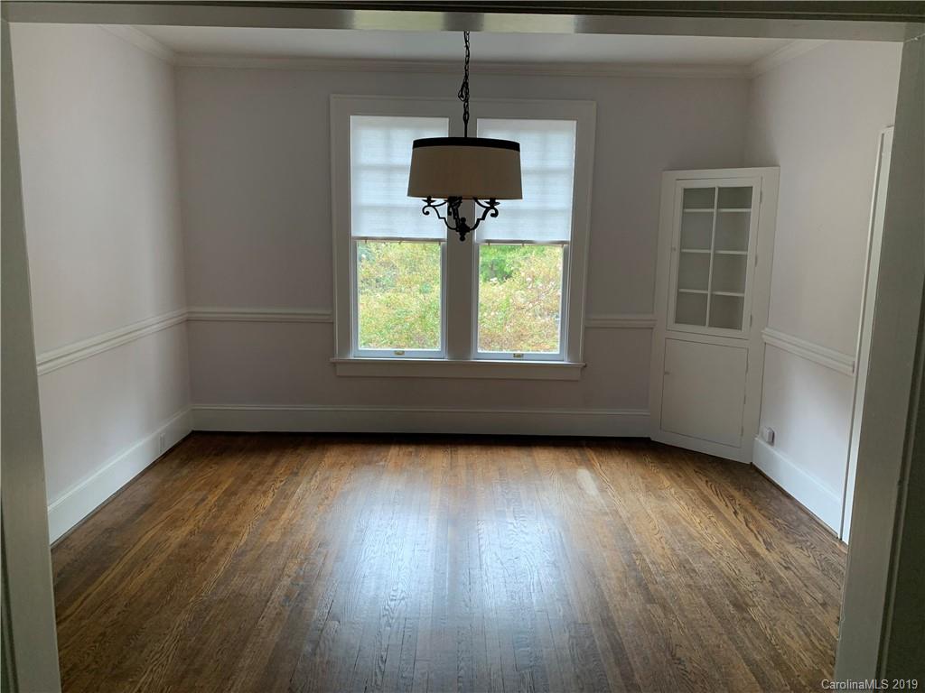224 Providence Road Charlotte, NC 28207 - Photo 5 of 27 a view of a room with wooden floor a ceiling fan and a window