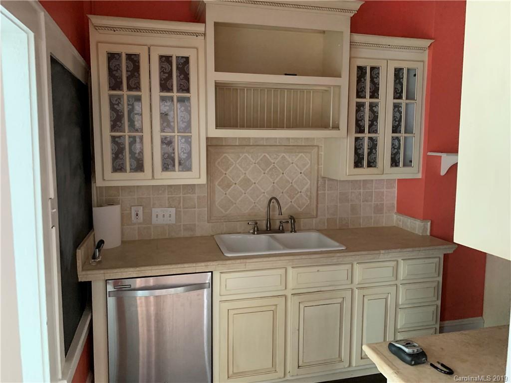 224 Providence Road Charlotte, NC 28207 - Photo 6 of 27 a kitchen with a sink and cabinets