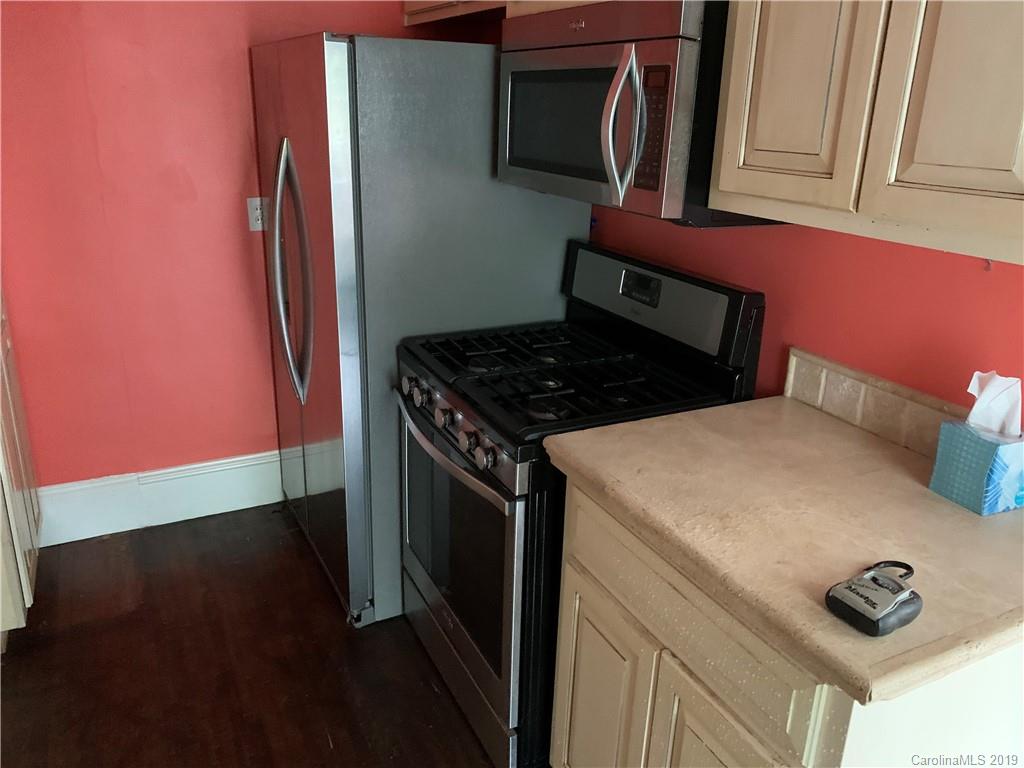 224 Providence Road Charlotte, NC 28207 - Photo 7 of 27 a kitchen with granite countertop a stove and a microwave