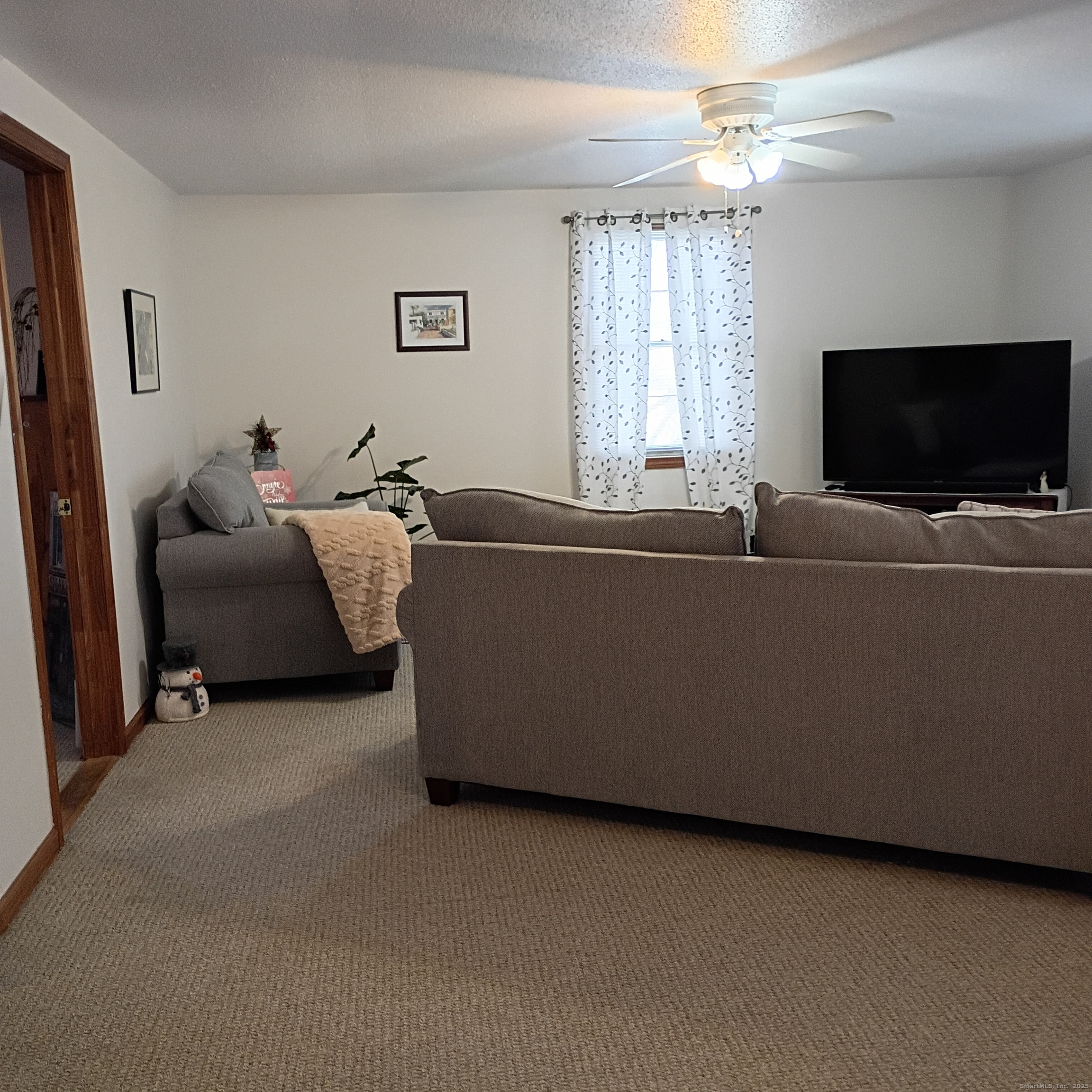 59 View Street, Unit 2 Bristol, CT 06010 - Photo 14 of 37 a living room with furniture and a flat screen tv