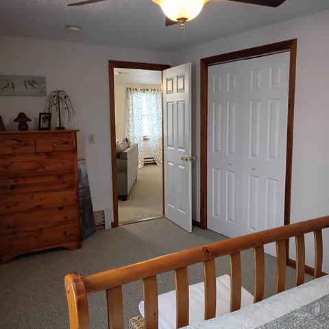 a view of a hallway with closet and cabinet