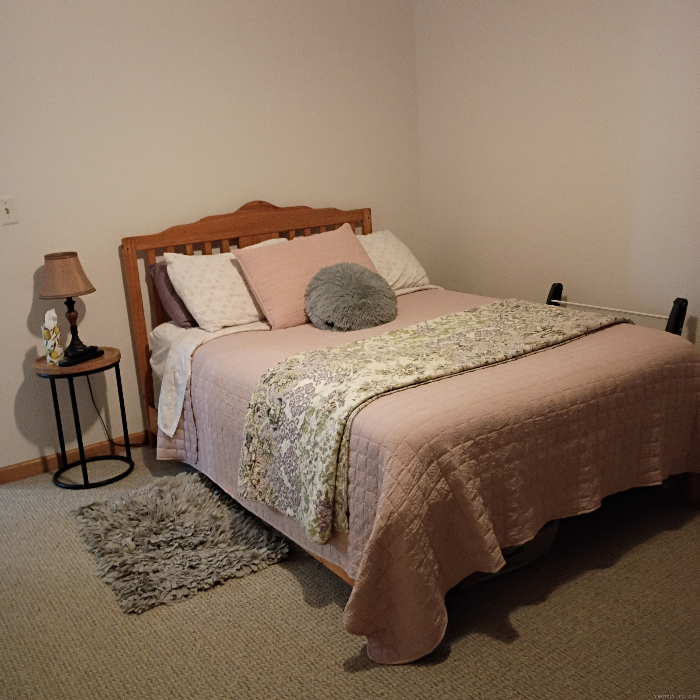 59 View Street, Unit 2 Bristol, CT 06010 - Photo 19 of 37 a bed sitting in a bedroom next to a lamp