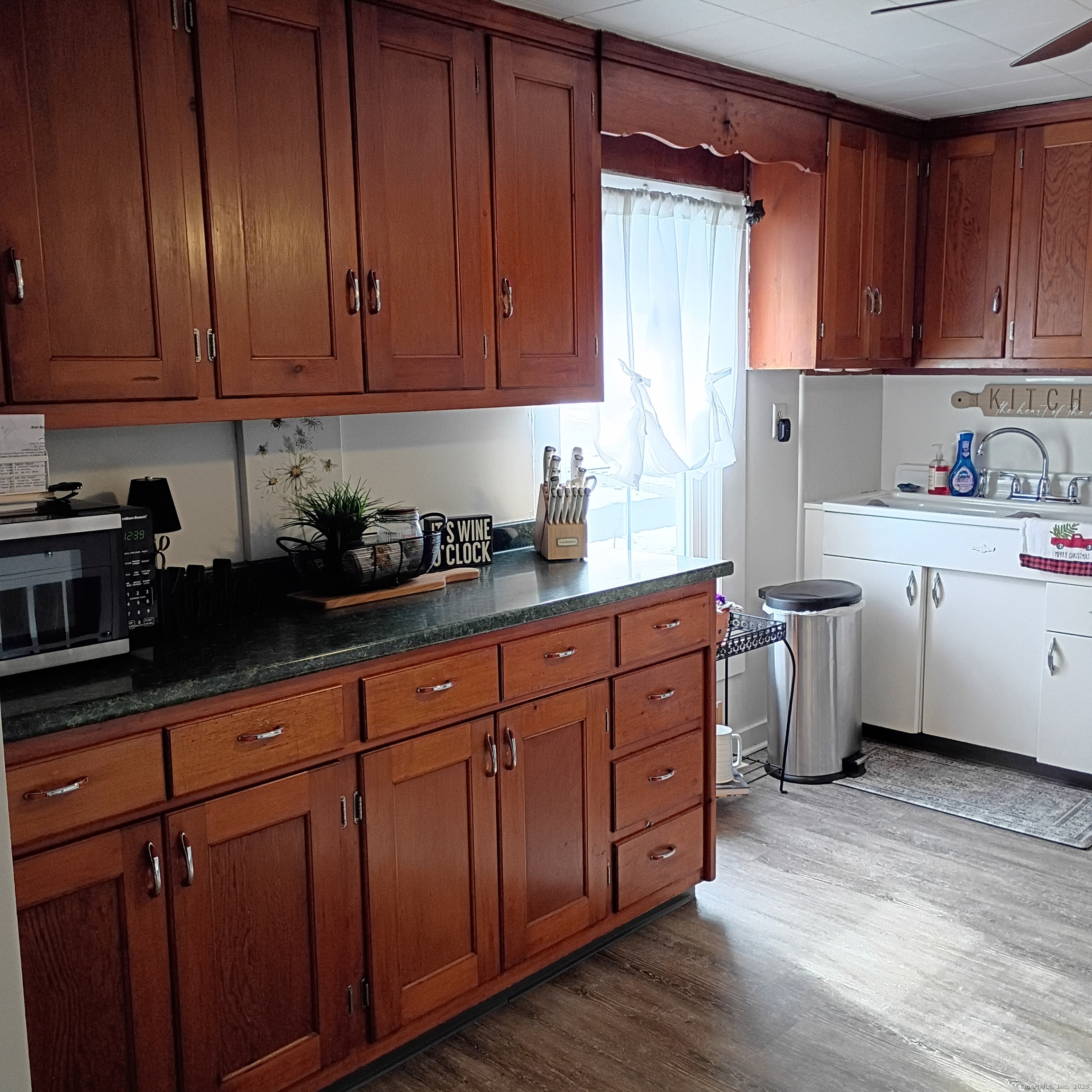 59 View Street, Unit 2 Bristol, CT 06010 - Photo 24 of 37 a kitchen with stainless steel appliances granite countertop wooden cabinets a sink and dishwasher with wooden floor