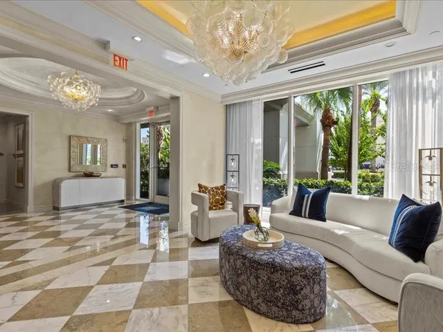 a living room with furniture and a floor to ceiling window