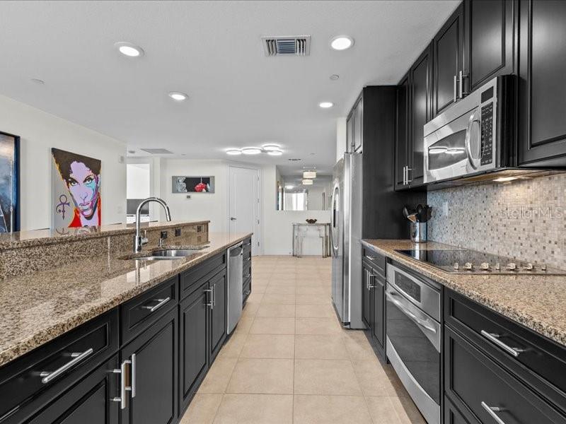 331 Cleveland Street, Unit 806 Clearwater, FL 33755 - Photo 26 of 83 a large kitchen with stainless steel appliances granite countertop a lot of counter space and wooden floor