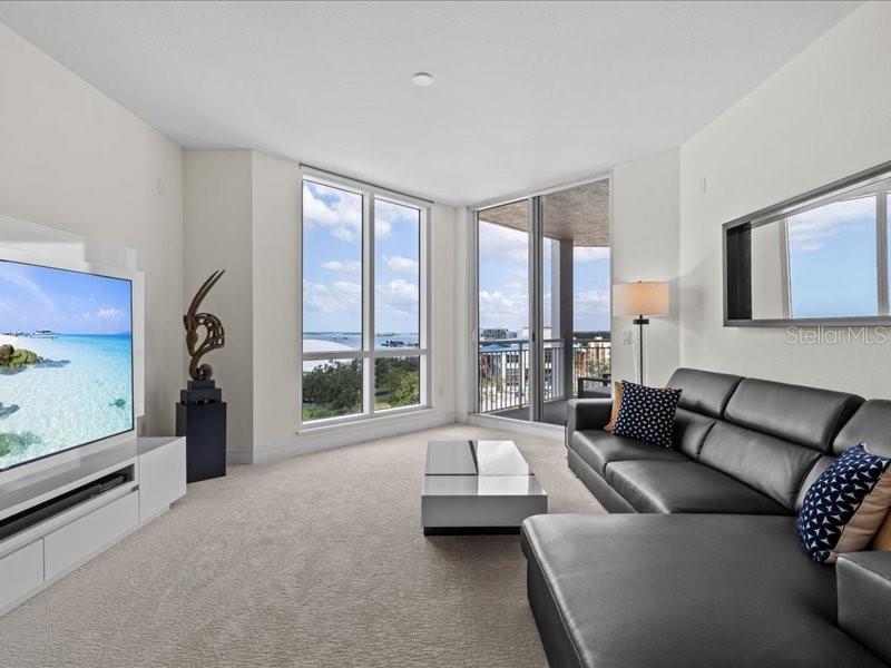 331 Cleveland Street, Unit 806 Clearwater, FL 33755 - Photo 30 of 83 a living room with furniture and a floor to ceiling window
