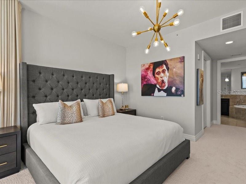 331 Cleveland Street, Unit 806 Clearwater, FL 33755 - Photo 42 of 83 a bedroom with a bed and a painting on the wall