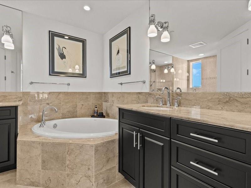 331 Cleveland Street, Unit 806 Clearwater, FL 33755 - Photo 44 of 83 a bathroom with a double vanity sink and a bathtub
