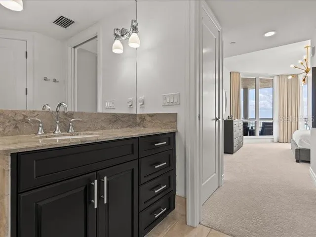 a room with pool table and windows