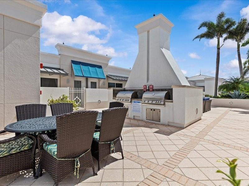 331 Cleveland Street, Unit 806 Clearwater, FL 33755 - Photo 60 of 83 a view of a chairs and table in the back yard of the house