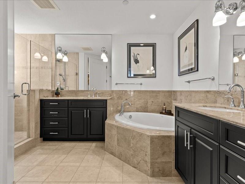 331 Cleveland Street, Unit 806 Clearwater, FL 33755 - Photo 6 of 83 a spacious bathroom with a granite countertop sink a toilet a mirror and bathtub
