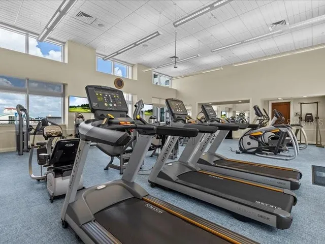 a kitchen with granite countertop a table chairs microwave and cabinets