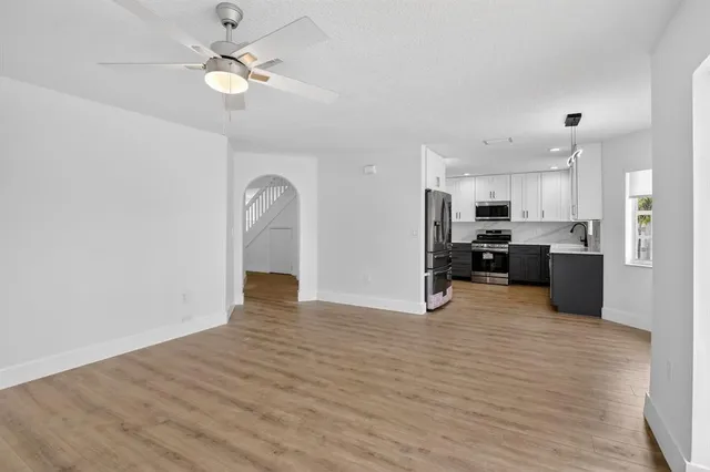 a view of a kitchen with a stove cabinets and wooden floor