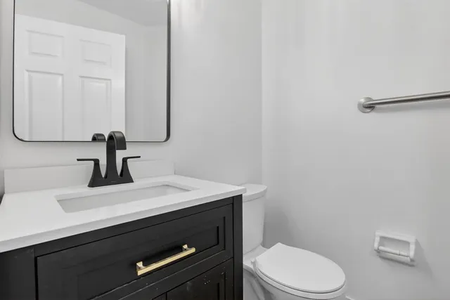 a view of an empty room with wooden floor and closet