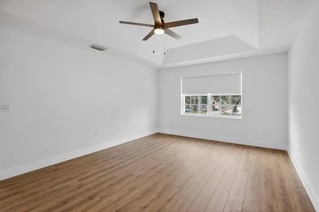 a view of walk in closet with wooden floor
