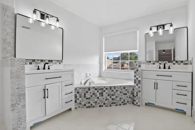 an empty room with wooden floor cabinet and a ceiling fan