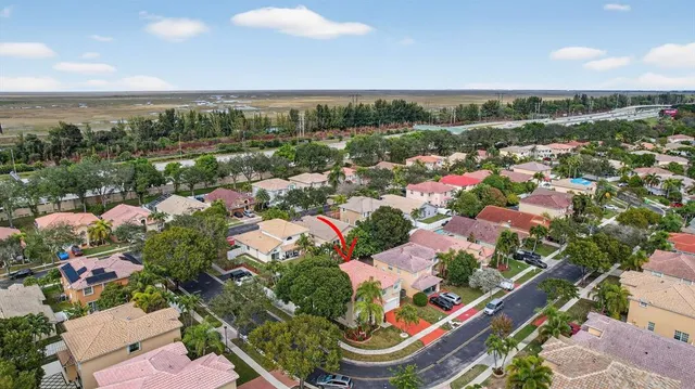 an aerial view of lake and residential houses with outdoor space