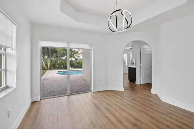 a view of room with window and wooden floor