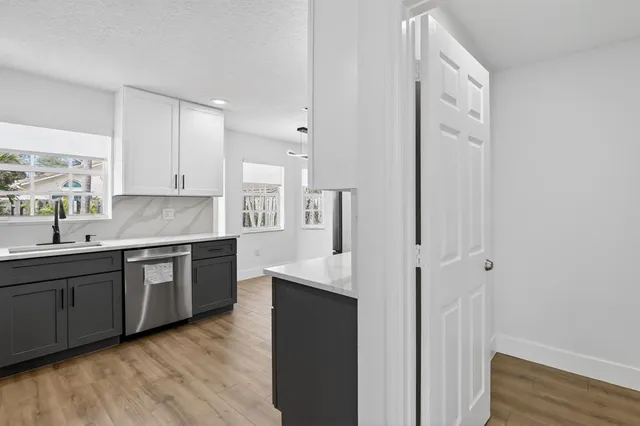a kitchen with stainless steel appliances stove microwave and cabinets