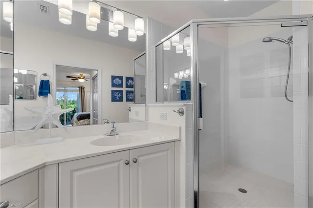 a bathroom with a sink a shower a mirror and a shower