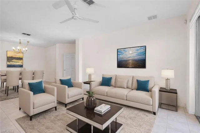 a living room with furniture a rug and a lamp