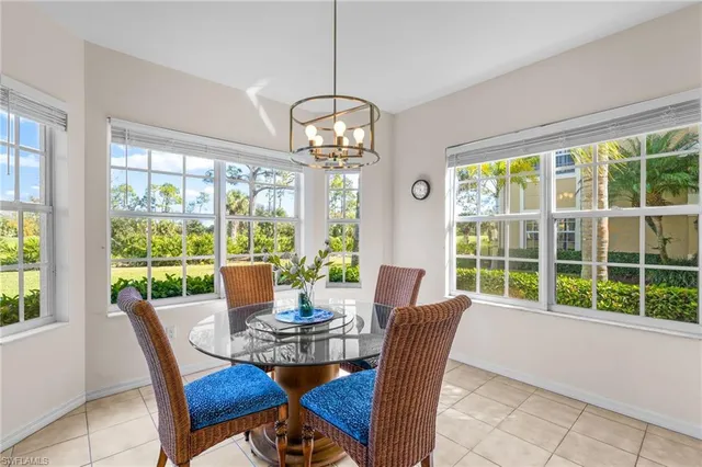 a view of a dining room with furniture large windows and wooden floor