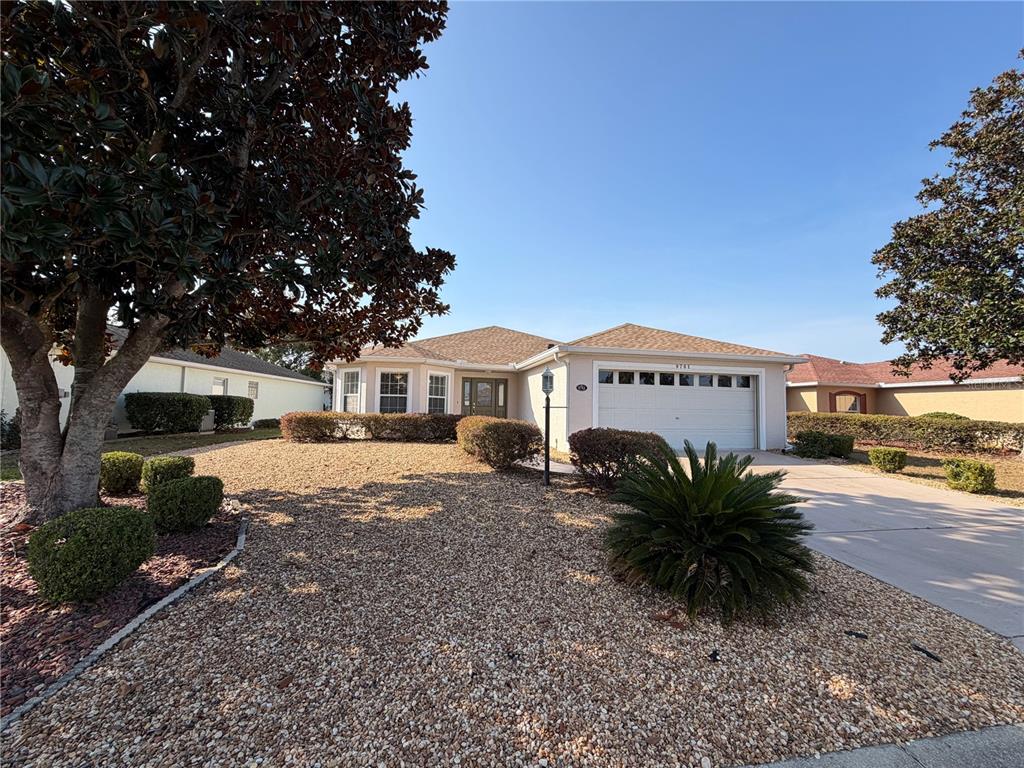 9761 Southwest 90th Street Ocala, FL 34481 - Photo 1 of 27 a front view of a house with a yard